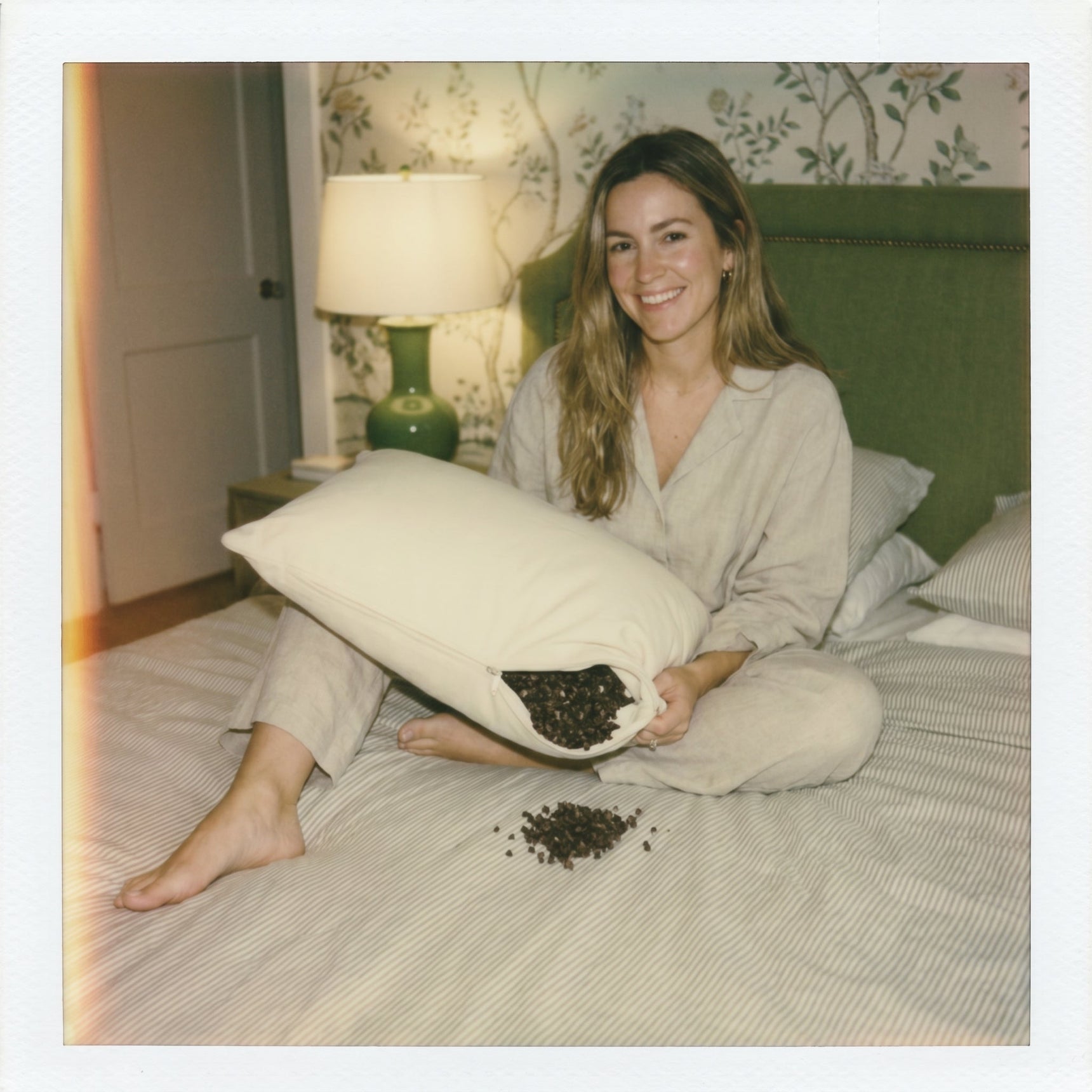 Person in linen pyjamas with Circadian Buckwheat Pillow shaped for cervical support