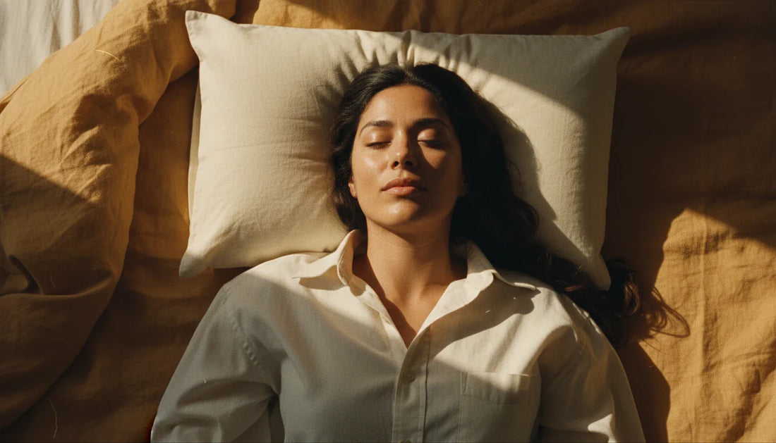 Latina woman sleeping on back on cream rectangular kapok pillow - overhead bird's-eye editorial shot