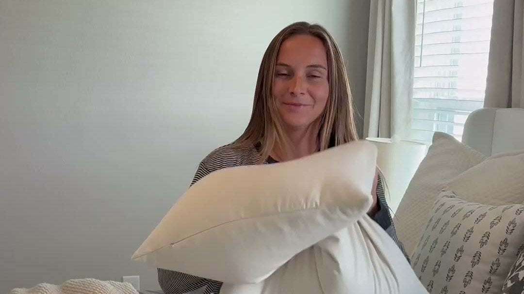 Jackie hugs her USA-Grown Buckwheat Pillow on her bed
