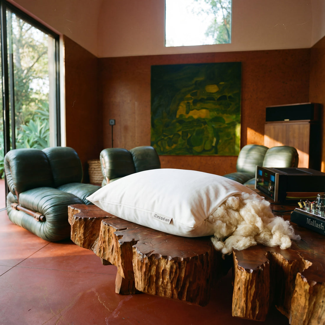 kapok pillows on a bed with a wooden headboard