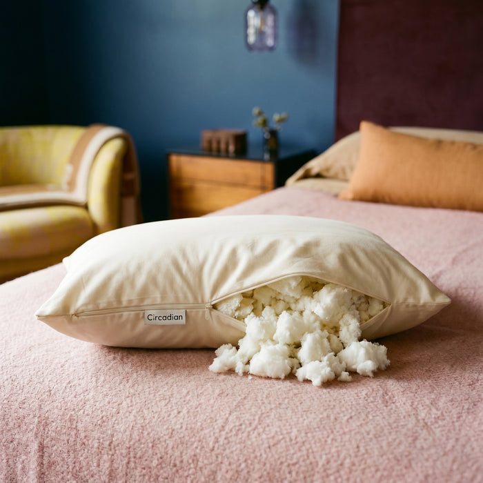 Tree-tapped latex pillow with slow-pour Dunlop latex fill on a pink boucle bed