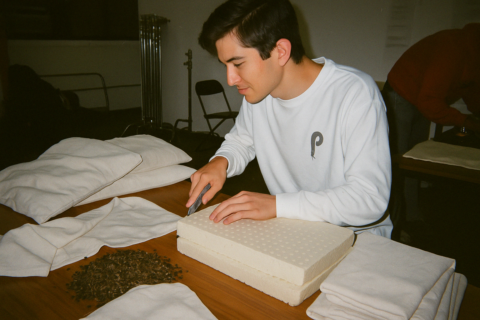 Assembling buckwheat pillows by hand in workshop