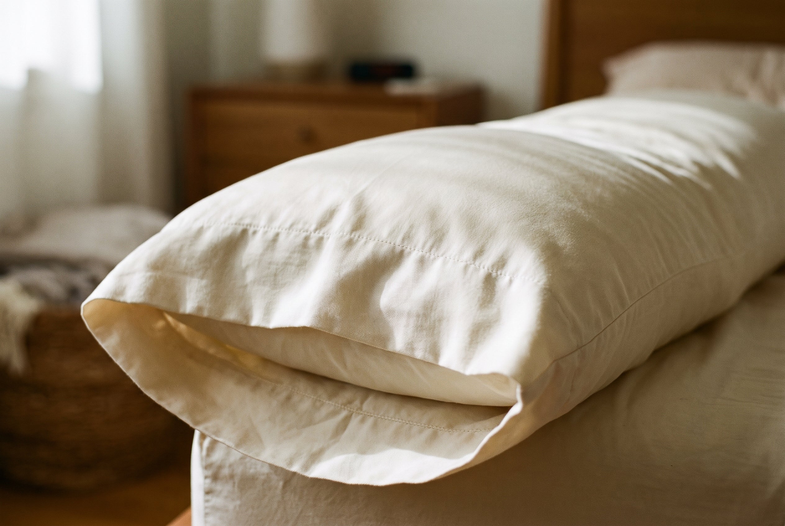 The plain hemmed opening of the organic cotton body pillow case