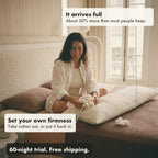 A smiling woman sitting on her bed takes a handful of cotton out of the Circadian Body Pillow to set its firmness; it arrives full, with about 30% more fill than most people keep.