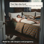 A woman sleeps on her side hugging the Circadian Body Pillow with her top knee resting on it, so her hips stay level; made for side sleepers and pregnancy.