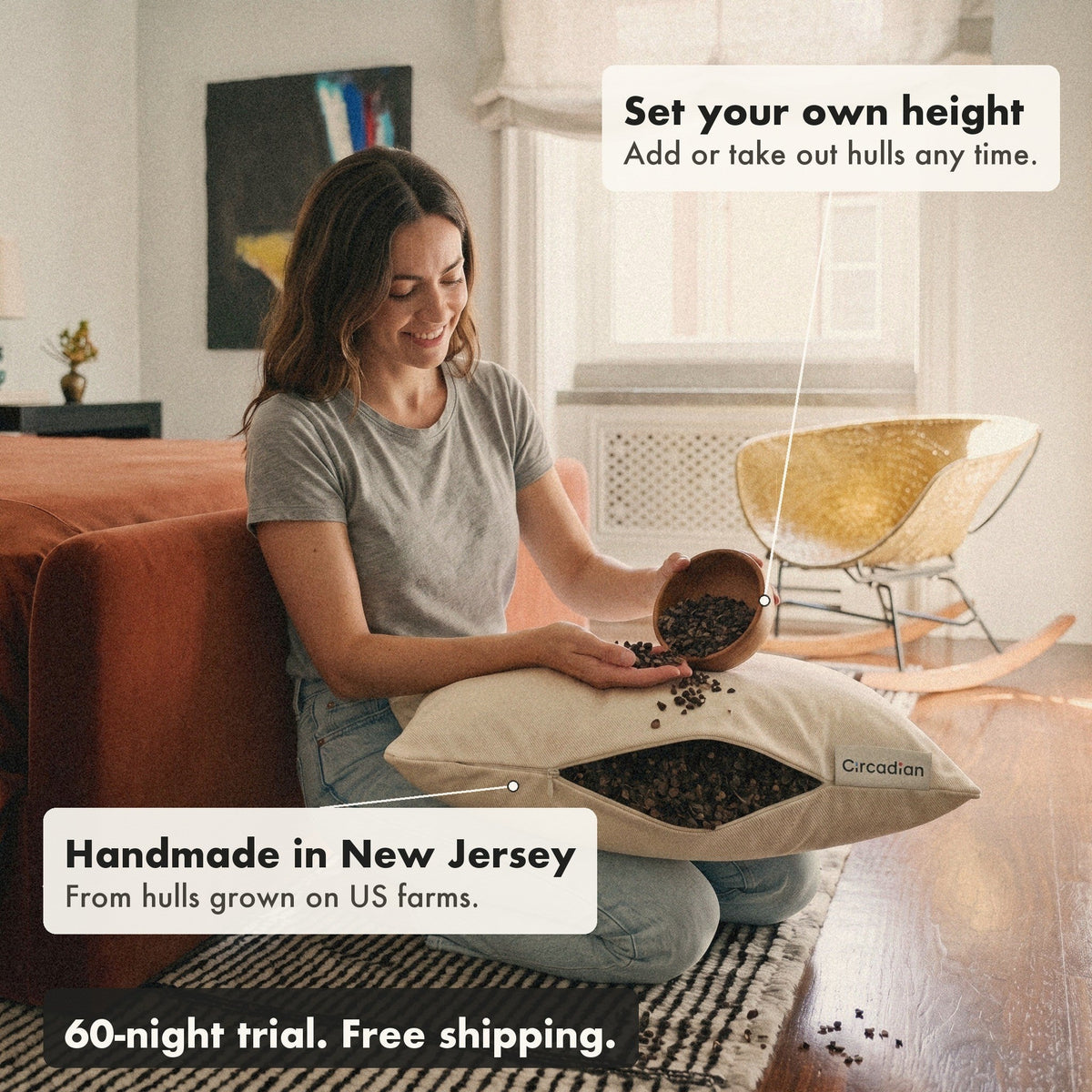 A woman kneeling on a rug pours buckwheat hulls from a wooden bowl into the Buckwheat Pillow to set its height, with labels: set your own height, handmade in New Jersey, 60-night trial, free shipping.
