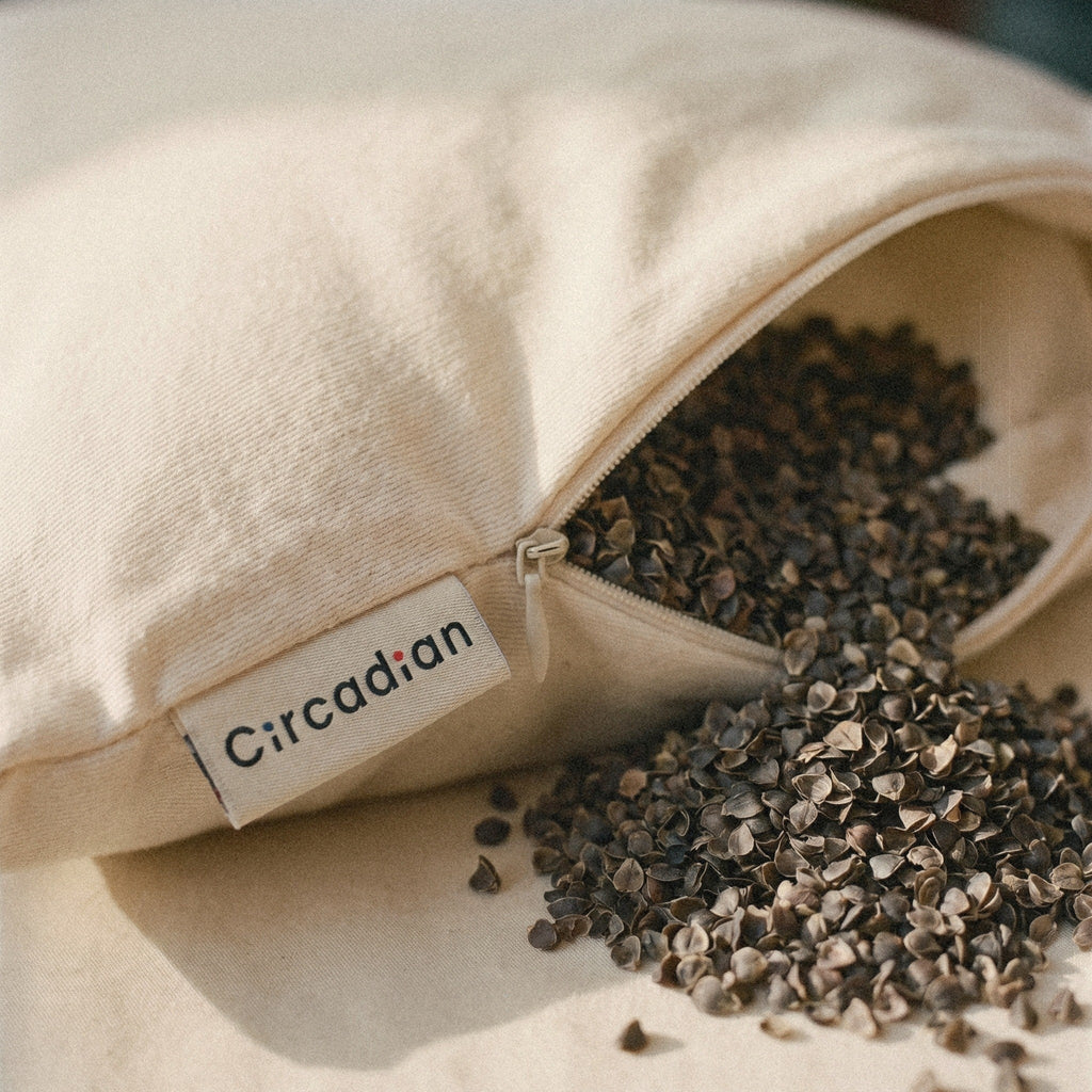 Close-up of the woven Circadian label beside the zipper of the Buckwheat Pillow, with buckwheat hulls spilling out.