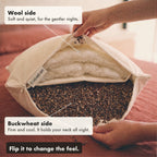 Hands hold the Buckwool Hybrid Pillow open. Wool sits in one chamber and hulls in the other, kept apart by a cotton divider, and the labels say the wool side is soft and quiet, the buckwheat side firm and cool, and you flip it to change the feel.