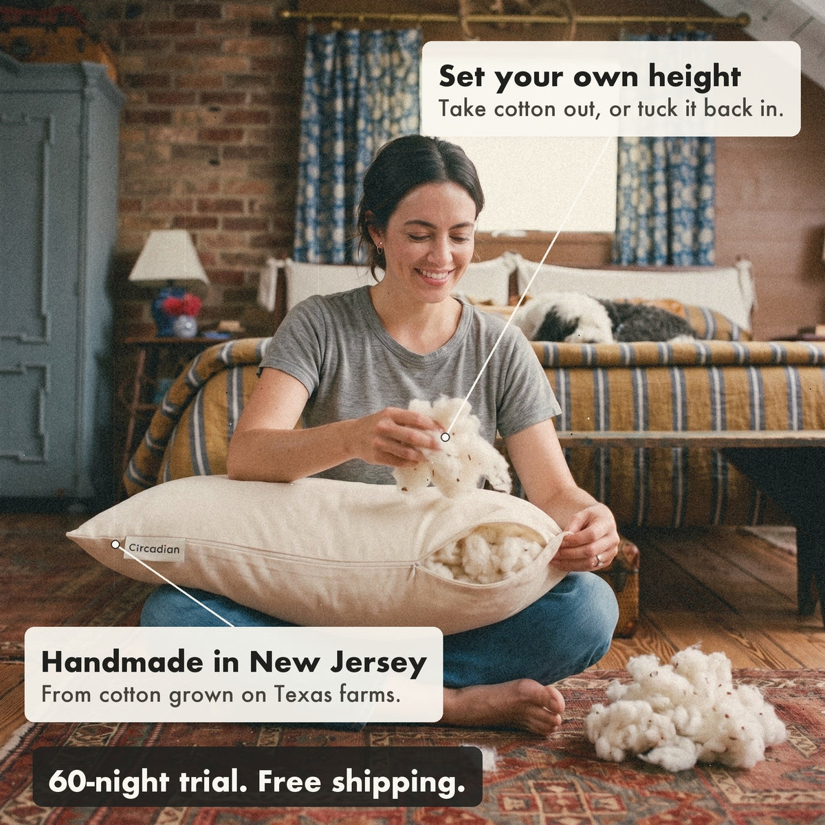 A smiling woman sitting on a rug takes cotton out of the Organic Cotton Pillow to set its height, with labels: set your own height, handmade in New Jersey, 60-night trial, free shipping.