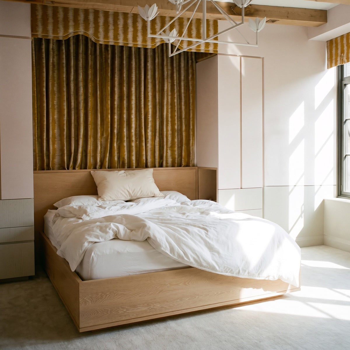 The Organic Cotton Pillow at the head of a double bed, showing its standard size against the mattress.