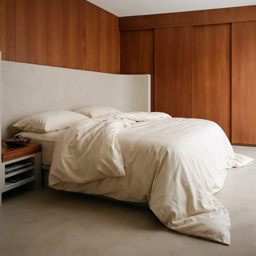 Organic cotton duvet cover on a bed in a cherry-panelled bedroom