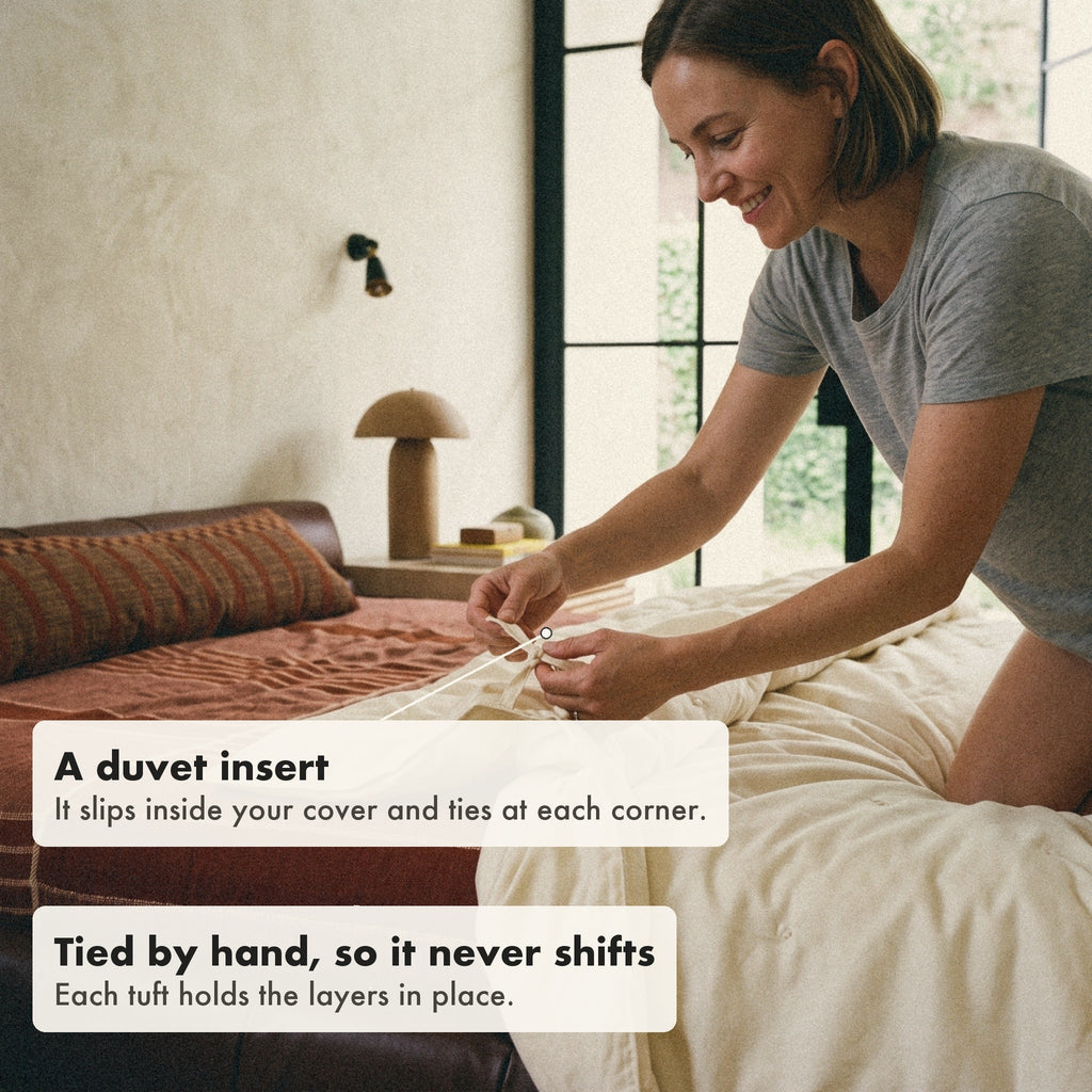 The cover is sold separately. Here a woman ties the corner loop of the comforter, a duvet insert, to the tie inside her own duvet cover.