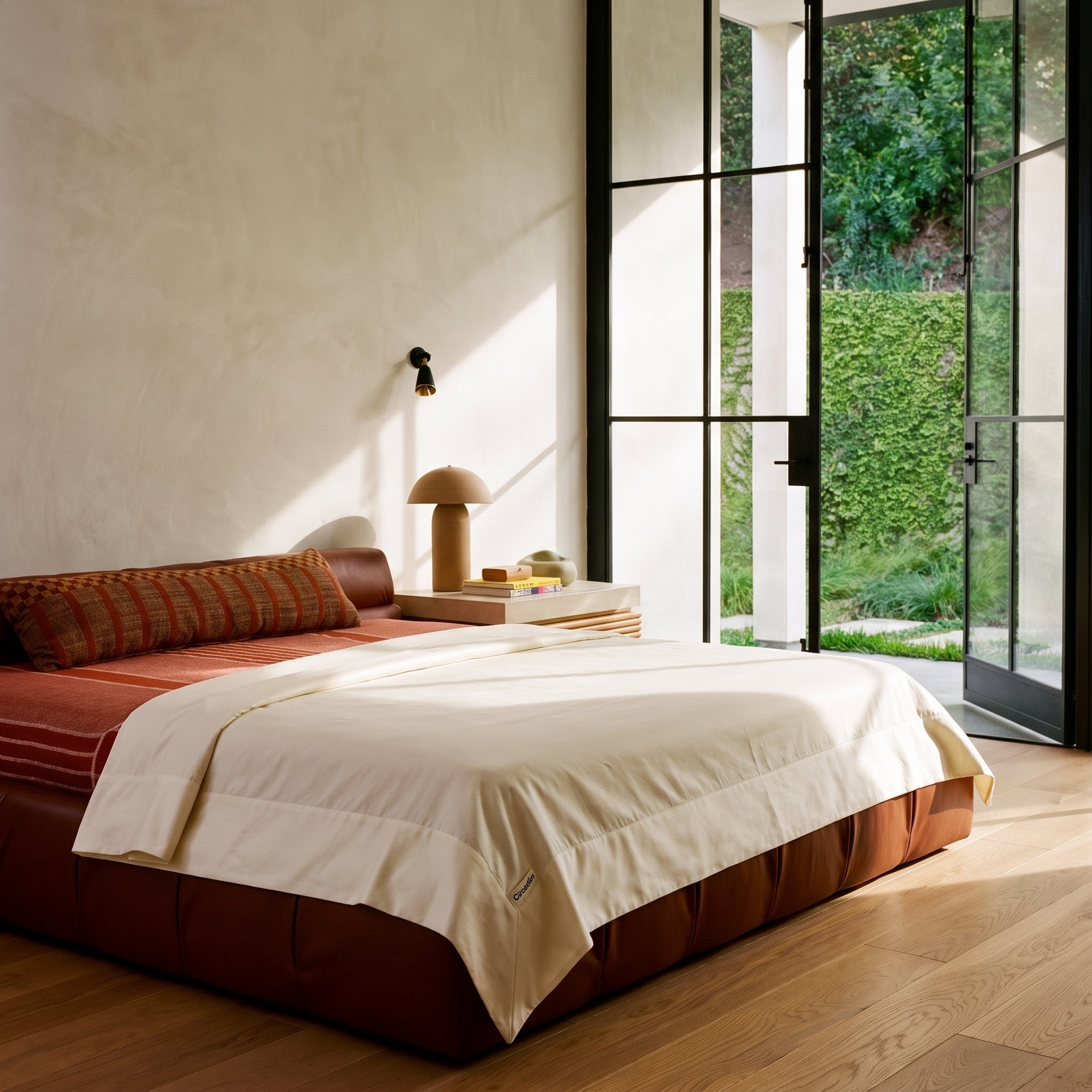 An organic cotton flat sheet folded back over a bed in a wide cuff