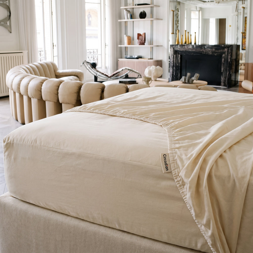 An organic cotton fitted sheet pulled taut over a deep mattress