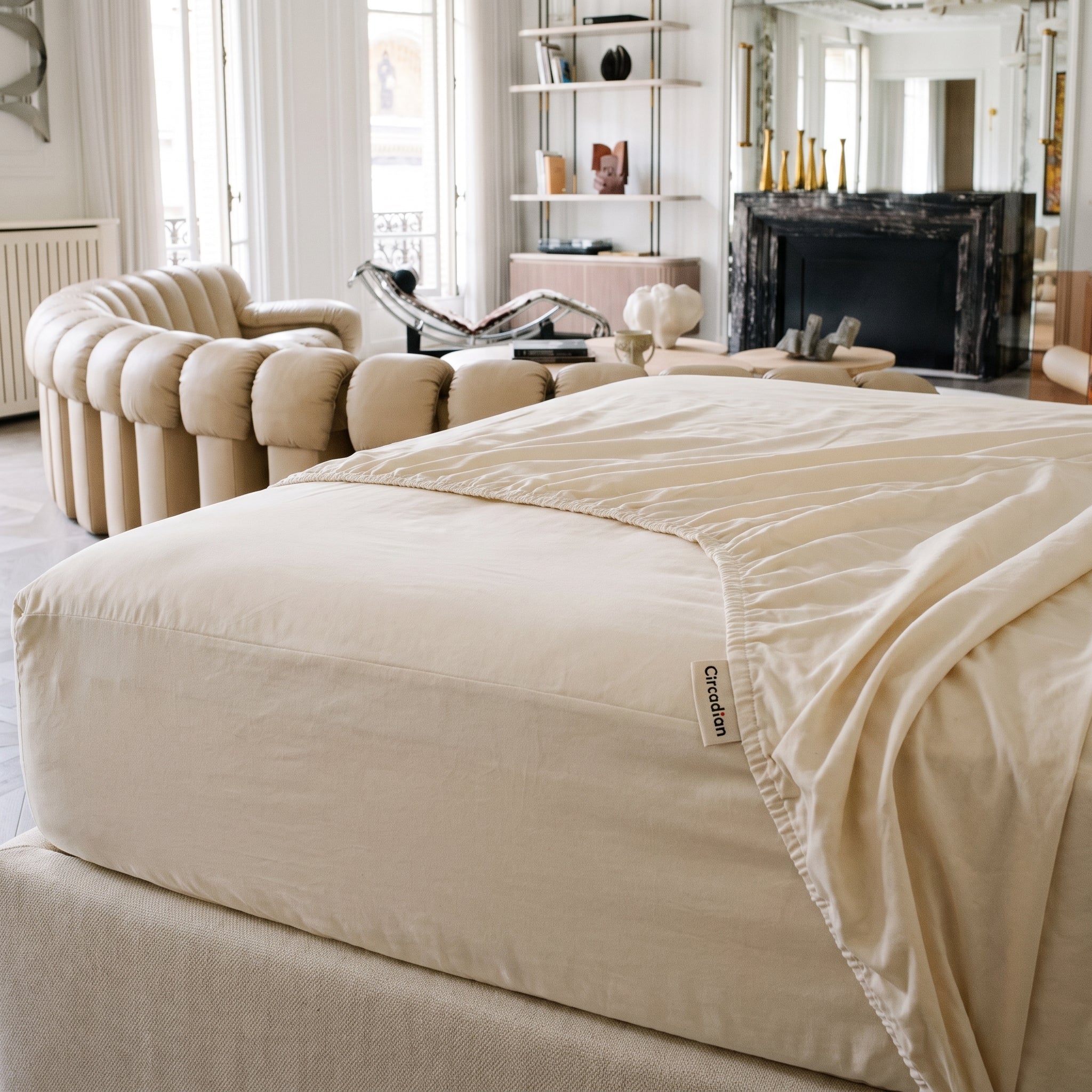 An organic cotton fitted sheet pulled taut over a deep mattress