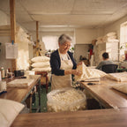 A worker in the New Jersey workshop fills a Circadian pillow cover by hand with shredded latex.