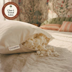 The woven Circadian label beside the open zipper of the Tree-Tapped Latex Pillow, soft pieces of latex spilling onto the bed, with a seal: Class 1 tested latex.