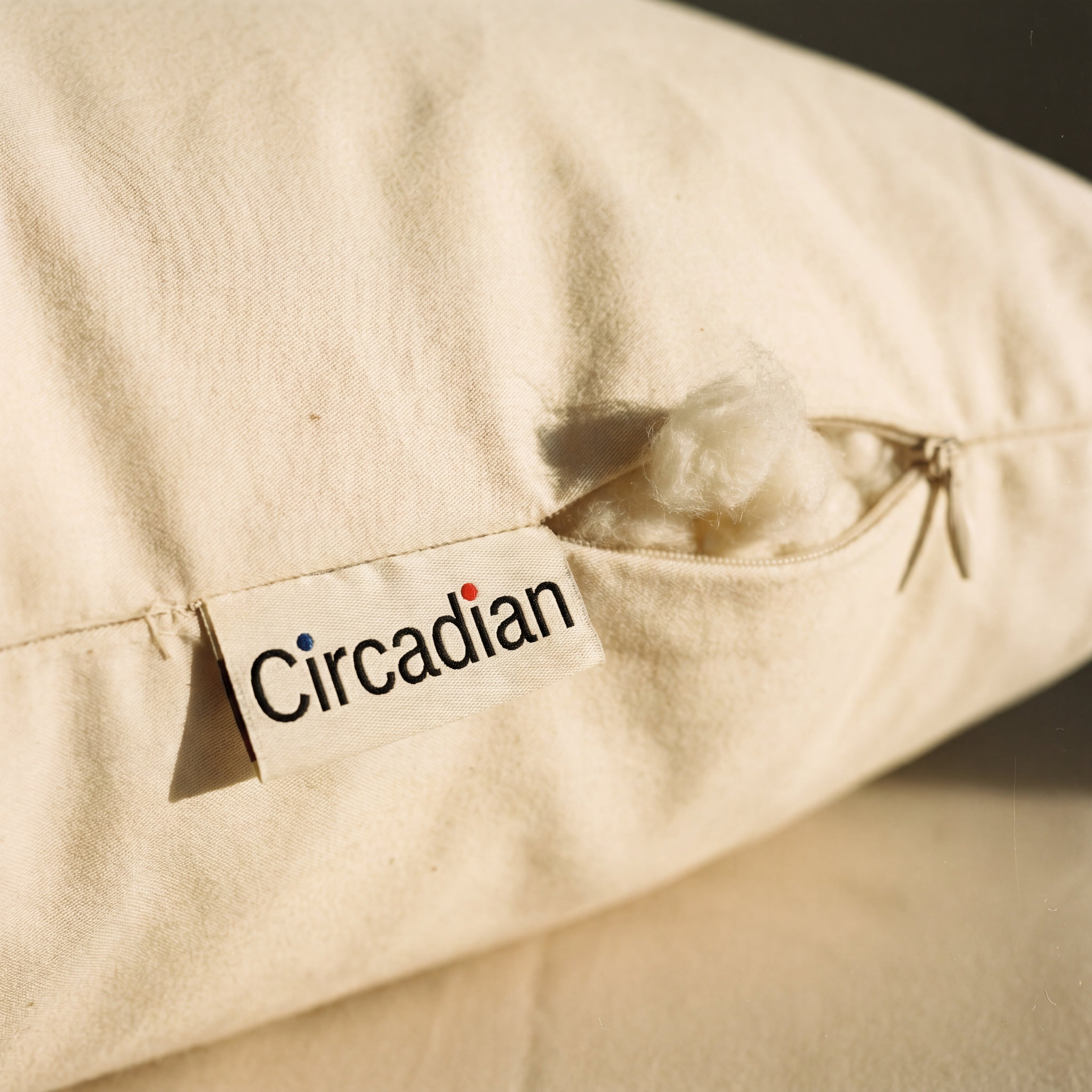 Concealed zipper and woven Circadian tag detail on the Organic Cotton Pillow's GOTS-certified sateen cover