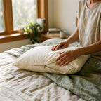 Sliding a pillow into the Circadian waterproof organic cotton pillow protector, full-length zipper open