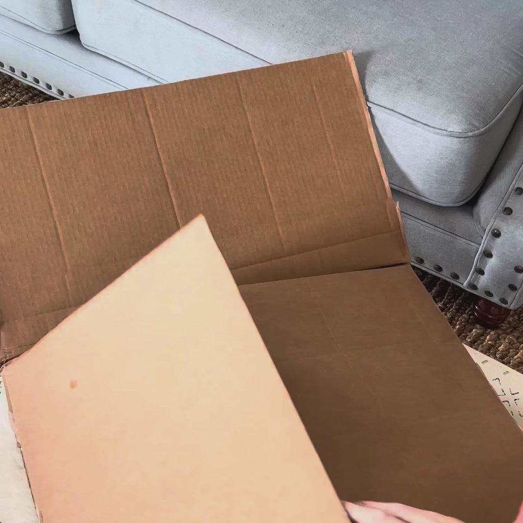 Opening a Circadian box, lifting out the Organic Cotton Pillow and unzipping it to show the cotton inside, then setting it on the bed.