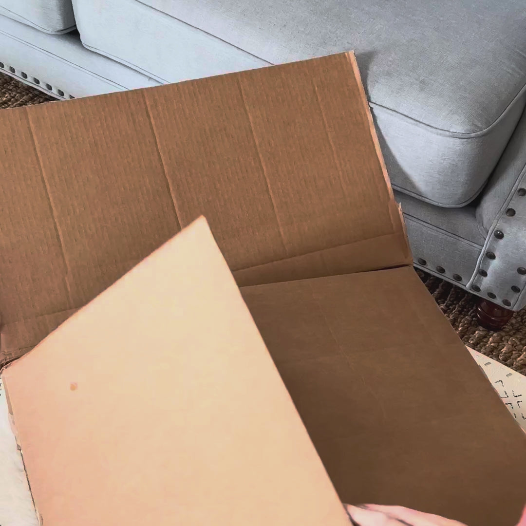 Opening a Circadian box, lifting out the Organic Cotton Pillow and unzipping it to show the cotton inside, then setting it on the bed.