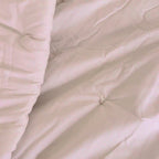 A slow pan across the small hand-tied tufts on a Circadian organic comforter.