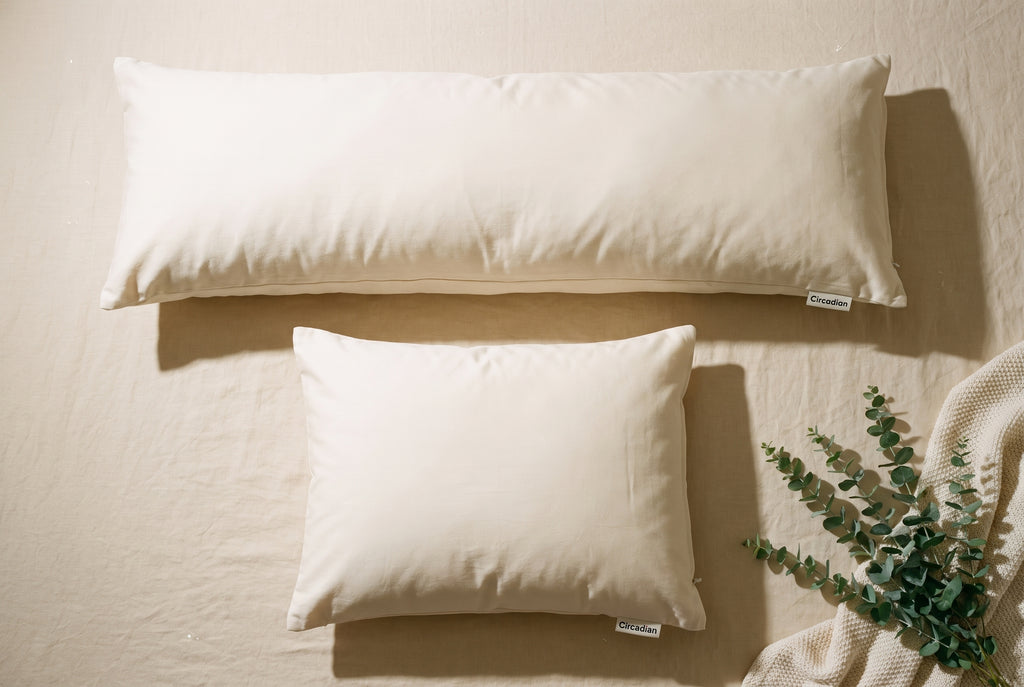 Overhead flatlay of the Circadian Body Pillow next to a standard Circadian pillow for size comparison.