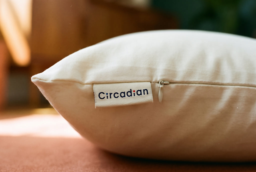 Close-up of the woven Circadian brand tag sewn onto the organic cotton body pillow cover, handmade in New Jersey.