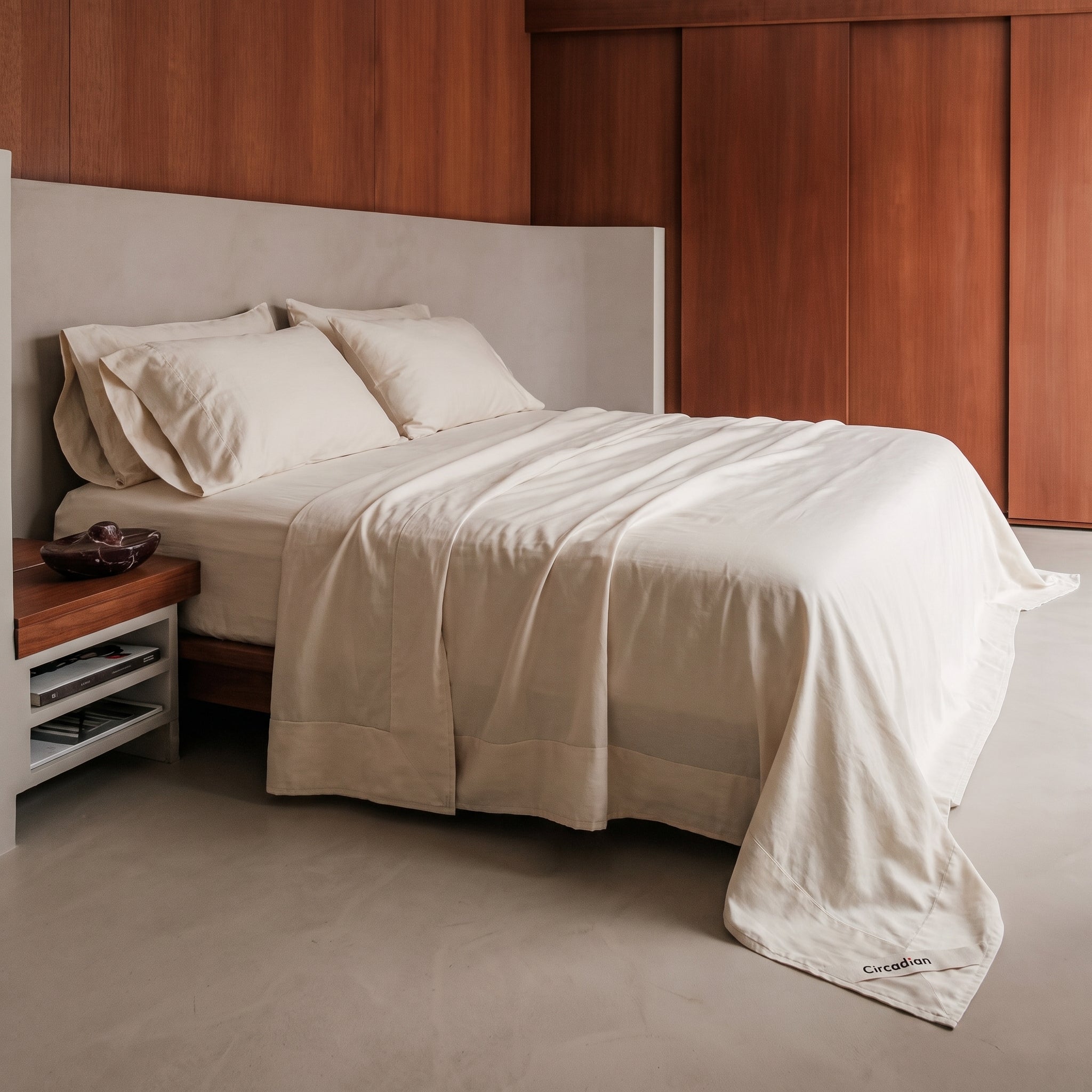 A bed made up in a full organic cotton sheet set