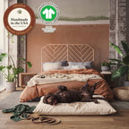 A damp labradoodle rolls on the waterproof dog bed cover. GOTS label (the Global Organic Textile Standard): GOTS-10229.