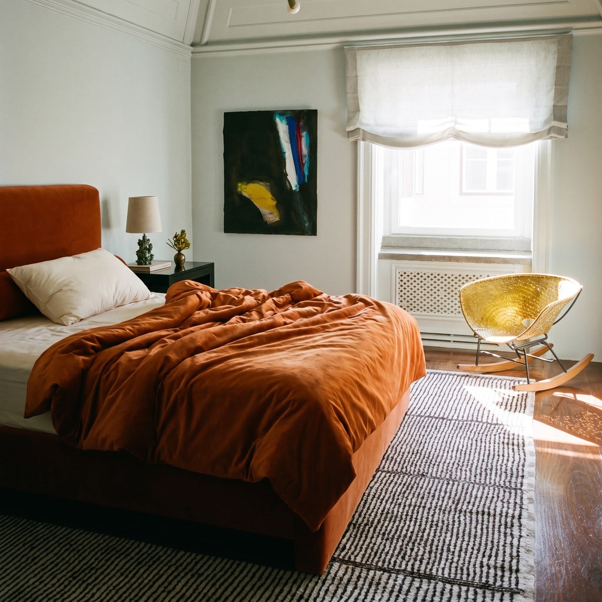 The Organic Wool Pillow at the head of a double bed, showing its standard size against the mattress.